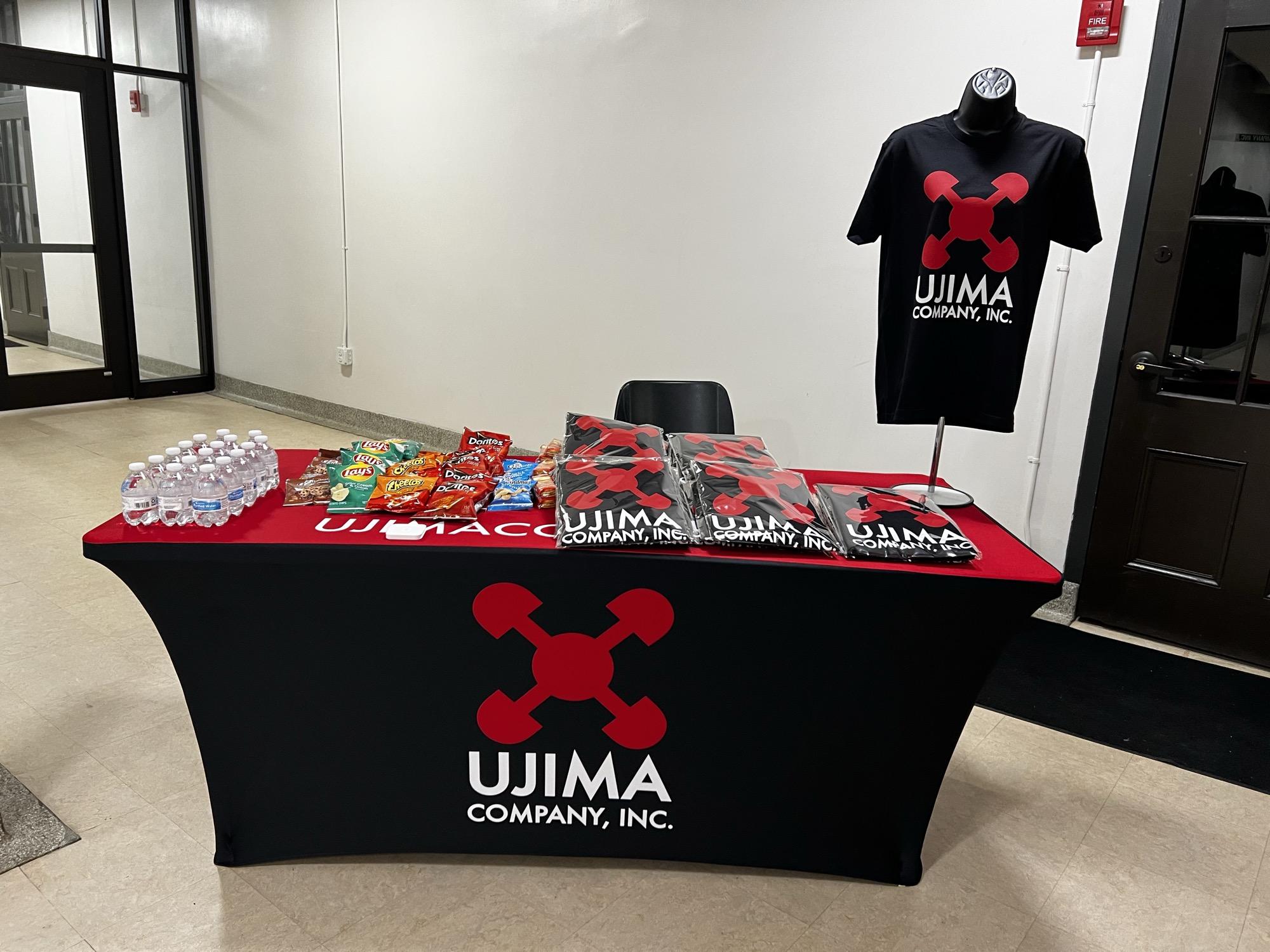 Ujima Company Inc branded event table and apparel